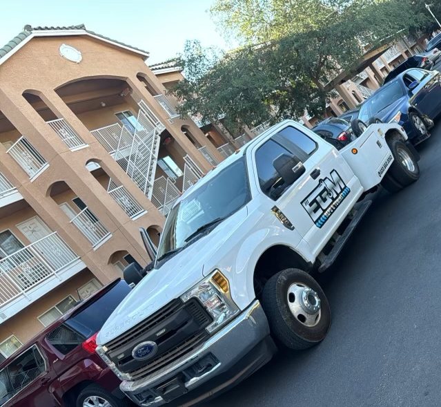 EGM tow truck recovering a vehicle at a Phoenix apartment complex