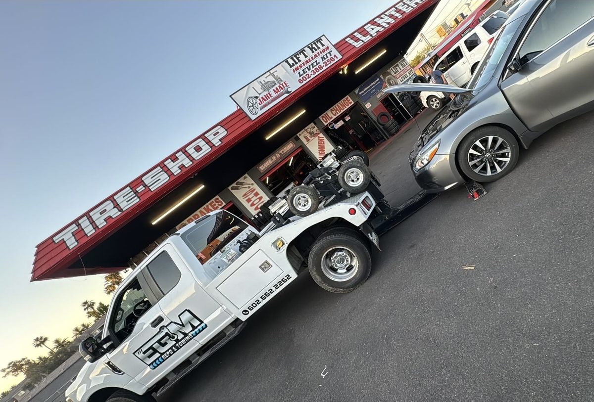 EGM tow truck delivering a vehicle to a Phoenix tire shop